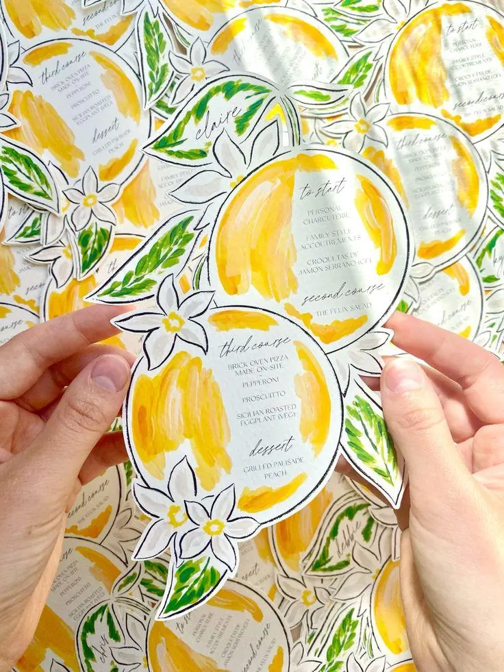 Hand-painted lemon die-cut wedding menus with guest names by StationeryWalaa